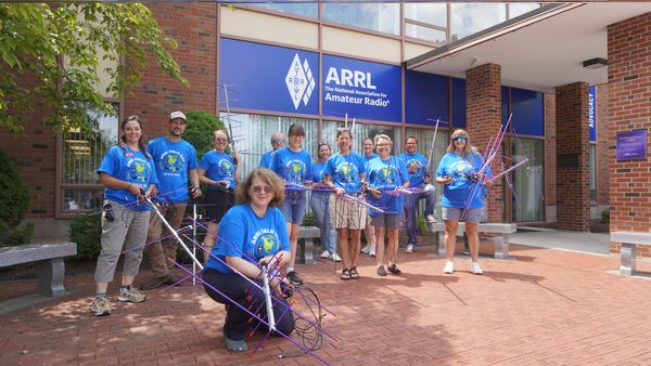A session of Teachers Institutes 1 in the summer of 2023 holding up their antennas outside ARRL headquarters.