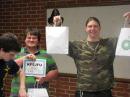 Josh Jenkins, KF5JFT (left) examines his new radio and Brandon Willadson, KF5JFU (center) and James Dickard, KF5JFV, are all smiles as they show off the rewards of their efforts.