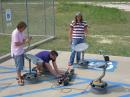 Court Sullivan, KF5HYE, James Boshart and Jake Rhodes, KF5HYD, complete
the calibration process on three radio-telescope units in preparation for an
interferometry research project in which the three units will be interconnected
to simulate a much larger dish. [Larry D. Barr, K5WLF, Photo]
