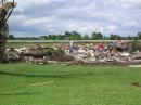 After a tornado destroyed his house, a man searches through the rubble. [Tony Everhardt, N8WAC, Photo] 