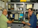 ARRL Puerto Rico Section Emergency Coordinator Carlos A. Rosado, KP4CAR (left) take reports from other amateurs on the LANTEX Caribe Wave exercise 2014 from PREMA Zone 6 office in Ponce. On the right is PREMA Director of Communications José M. Ríos, WP4KUY. (Photo courtesy of Carlos Rosado, KP4CAR)