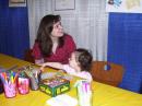 A young visitor to the RARSfest Youth Lounge gets help with her Morse Code bracelet. [Andrea Hartlage, KG4IUM, Photo]