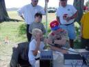 Bill Henderson, K0VBU, of Overland Park, Kansas, helps a Cub with mic fright.