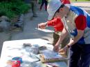 Ten minutes before their start times, competitors are given their orienteering maps and can mount them on map boards if they wish. They also mark the start, finish and exclusion zones. Preparing their maps before the 80 meter event are Matthias Kuehlewein, DL3SDO (closest to the camera), and Bill Noyce, AB1AV. 